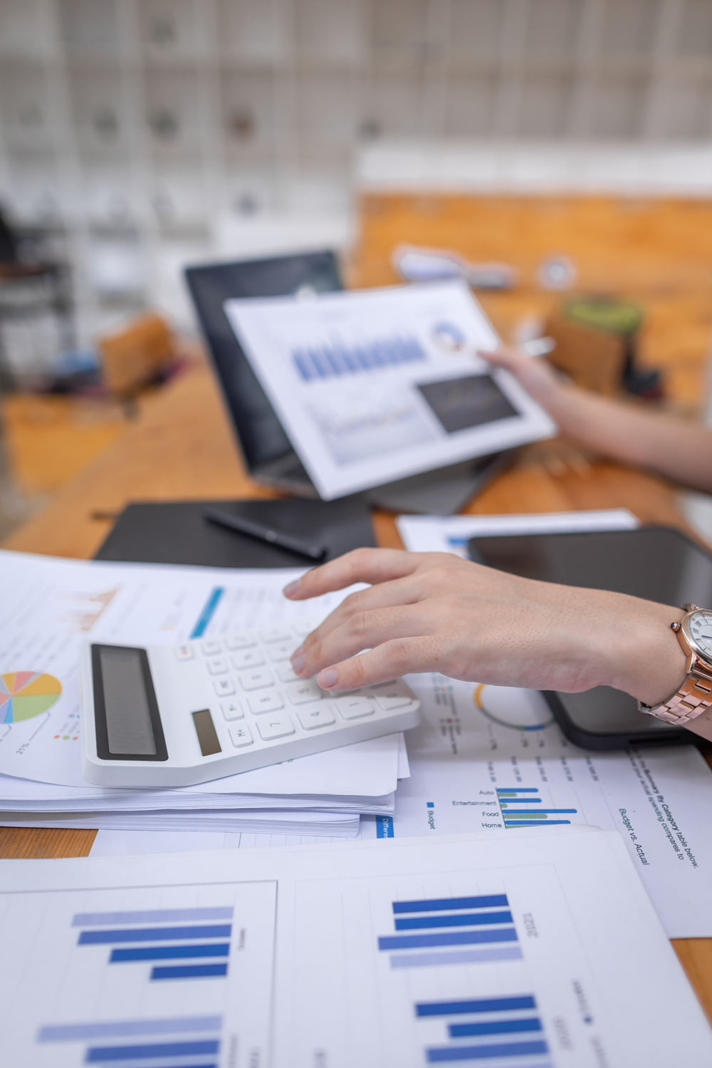 Person calculating financial data with electronic device