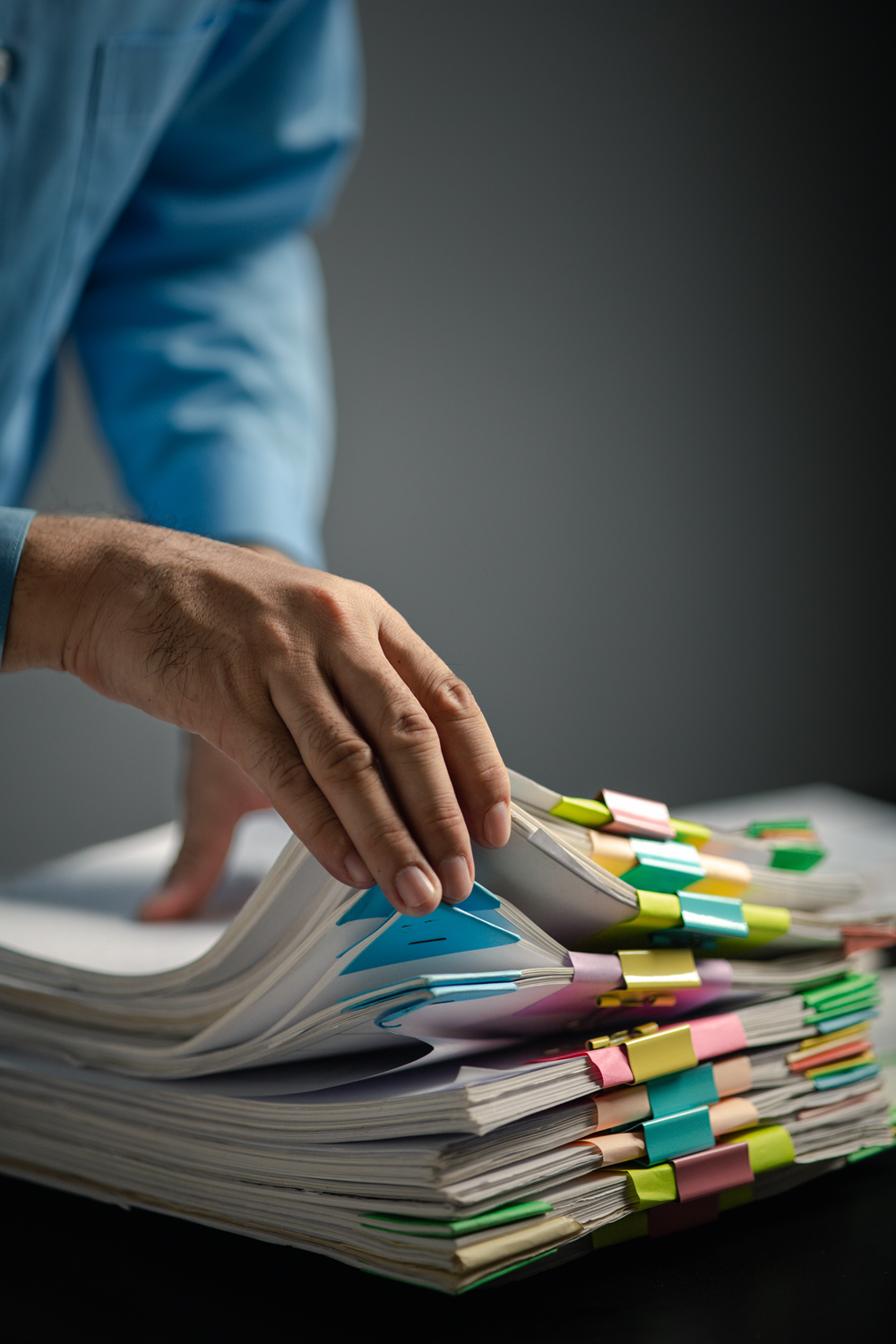 Organizing paperwork with colorful binder clips