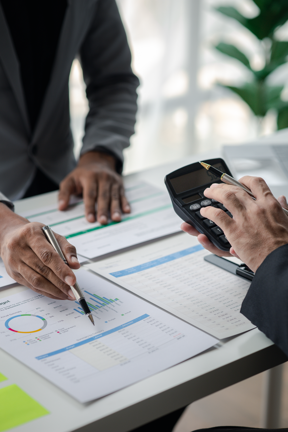 Business professionals analyzing financial documents and calculator