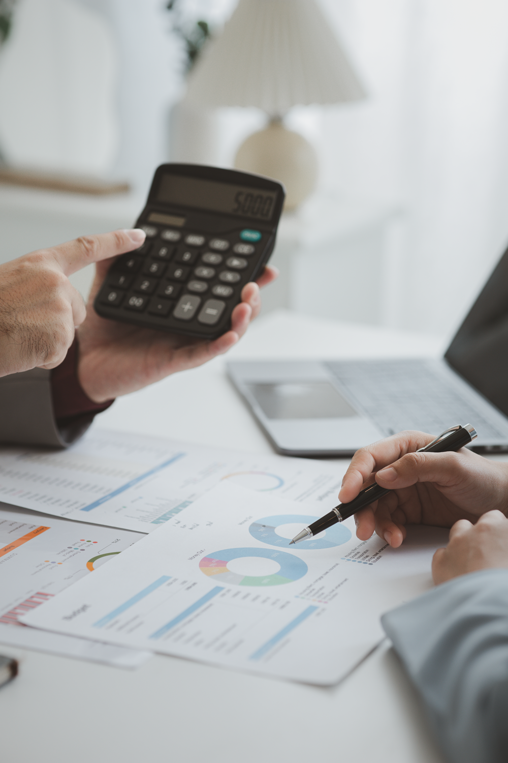 Team analyzing financial data with calculator insights