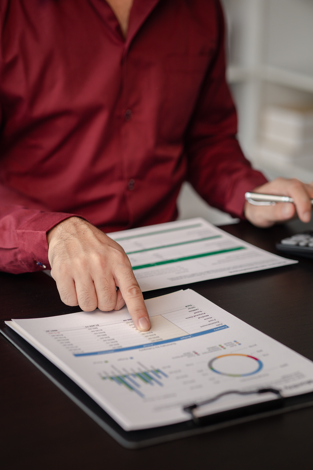 Man analyzing financial graphs and data reports