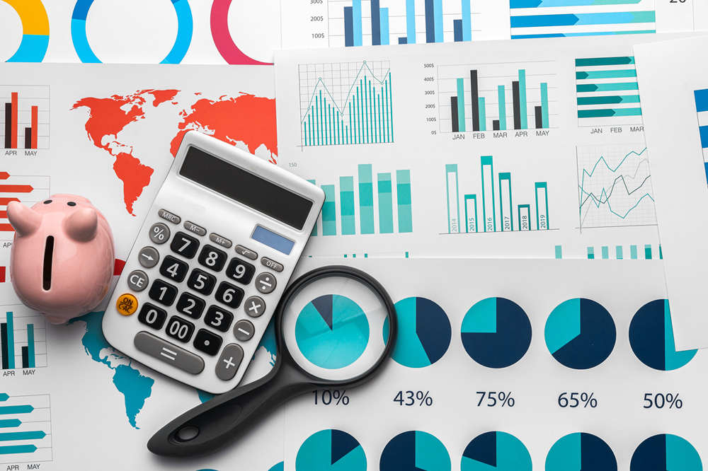 Calculator and charts on financial analysis table.